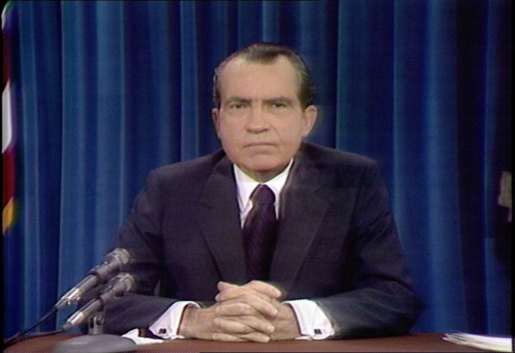 President Nixon sitting at his desk giving a speech